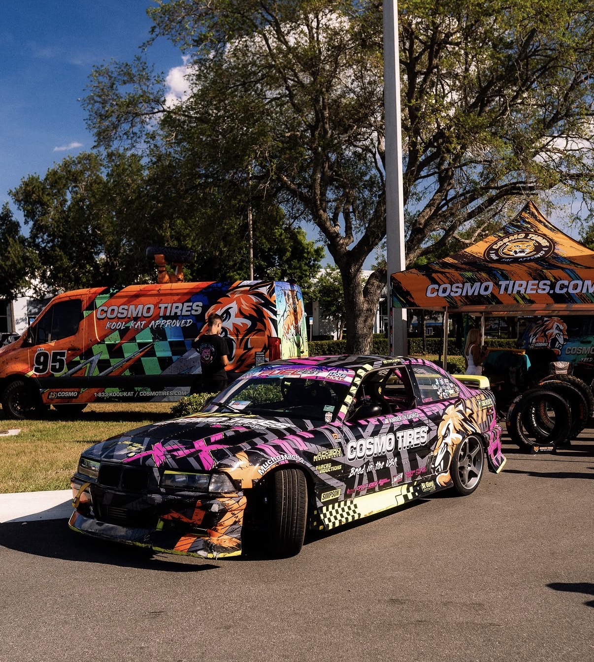 Cosmo Tires drift BMW with magenta and yellow livery